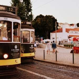 Charming view of Lisbon trams and street scene at Praça da Figueira, Portugal.