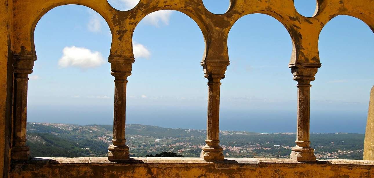 Gorgeous ocean view through vintage arches at Sintra Palace, Portugal.