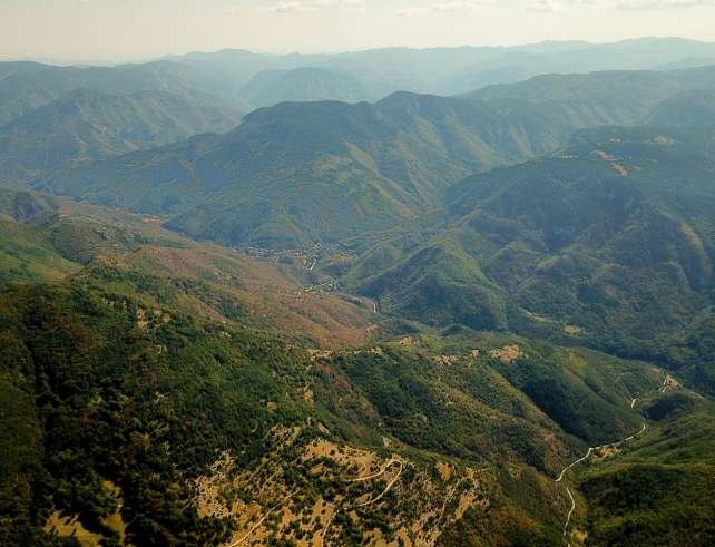 Scenic aerial view of verdant mountain ranges in Bulgaria captured during summer daylight.