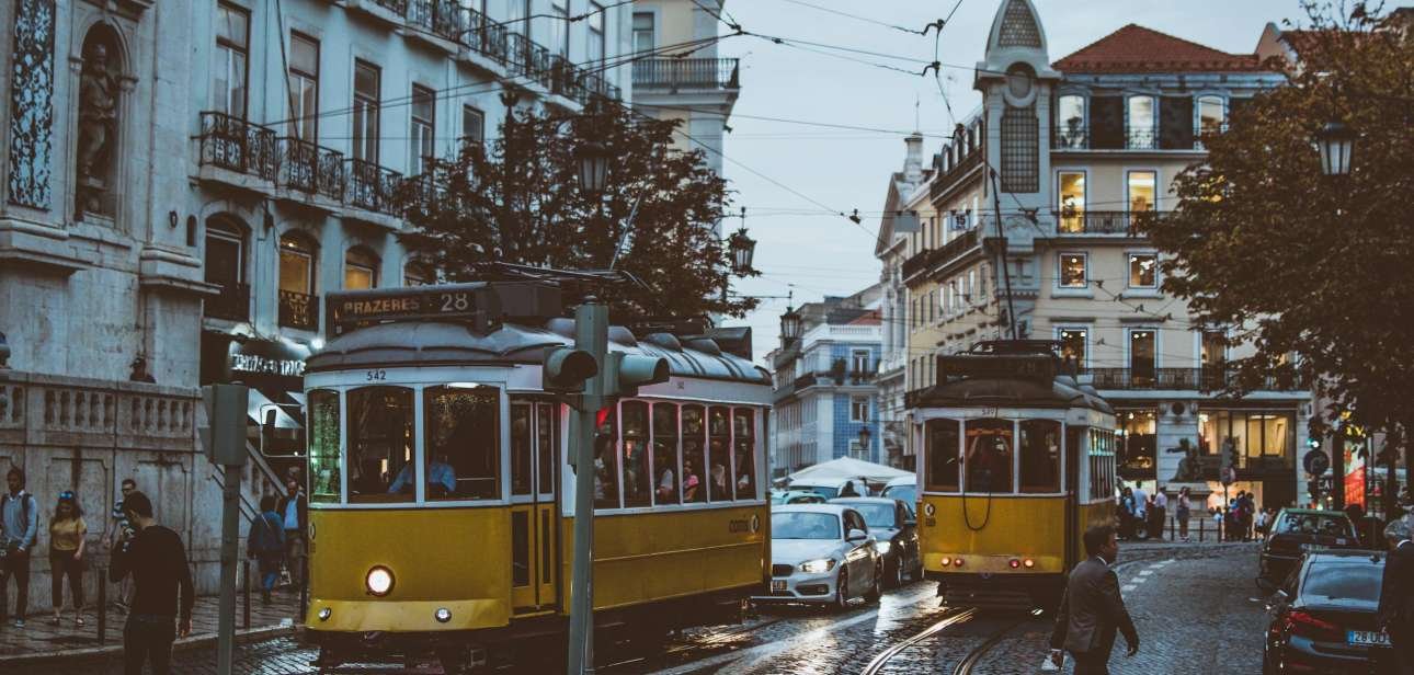 Scenic view of trams navigating the charming streets of Lisbon at dusk, capturing urban life and transportation.