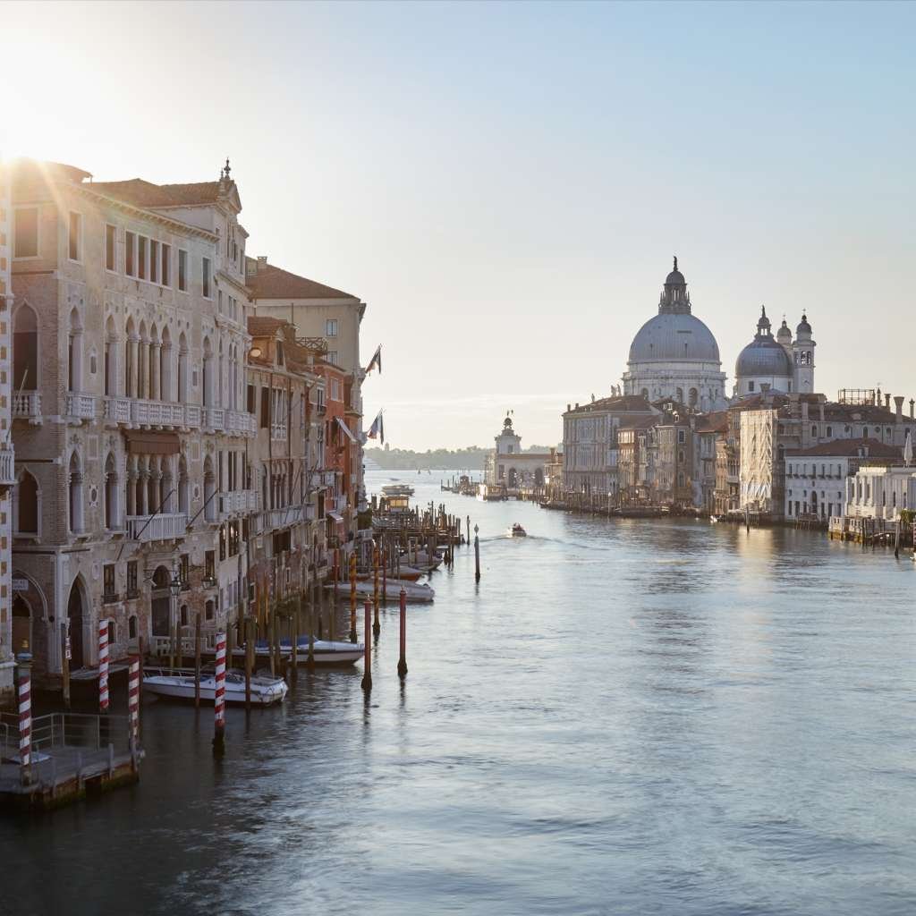 Grand Canal in Venice with Saint Mary of Health basilica, sun in Italy